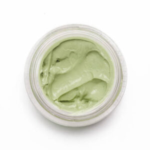 Green clay facial mask in container isolated on white background, top view